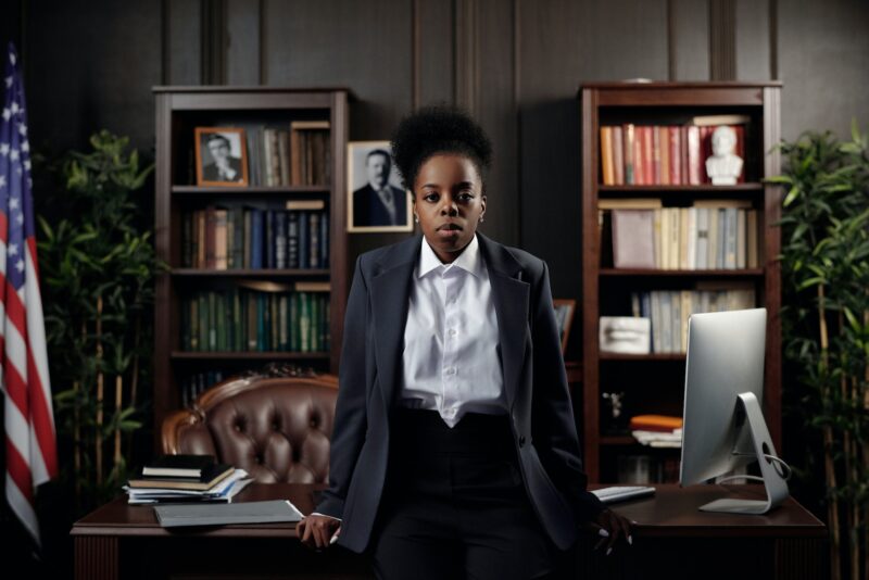 A black female lawyer standing at her desk