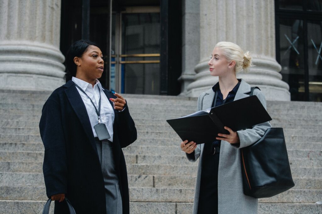 Two women standing in front of a courthouse